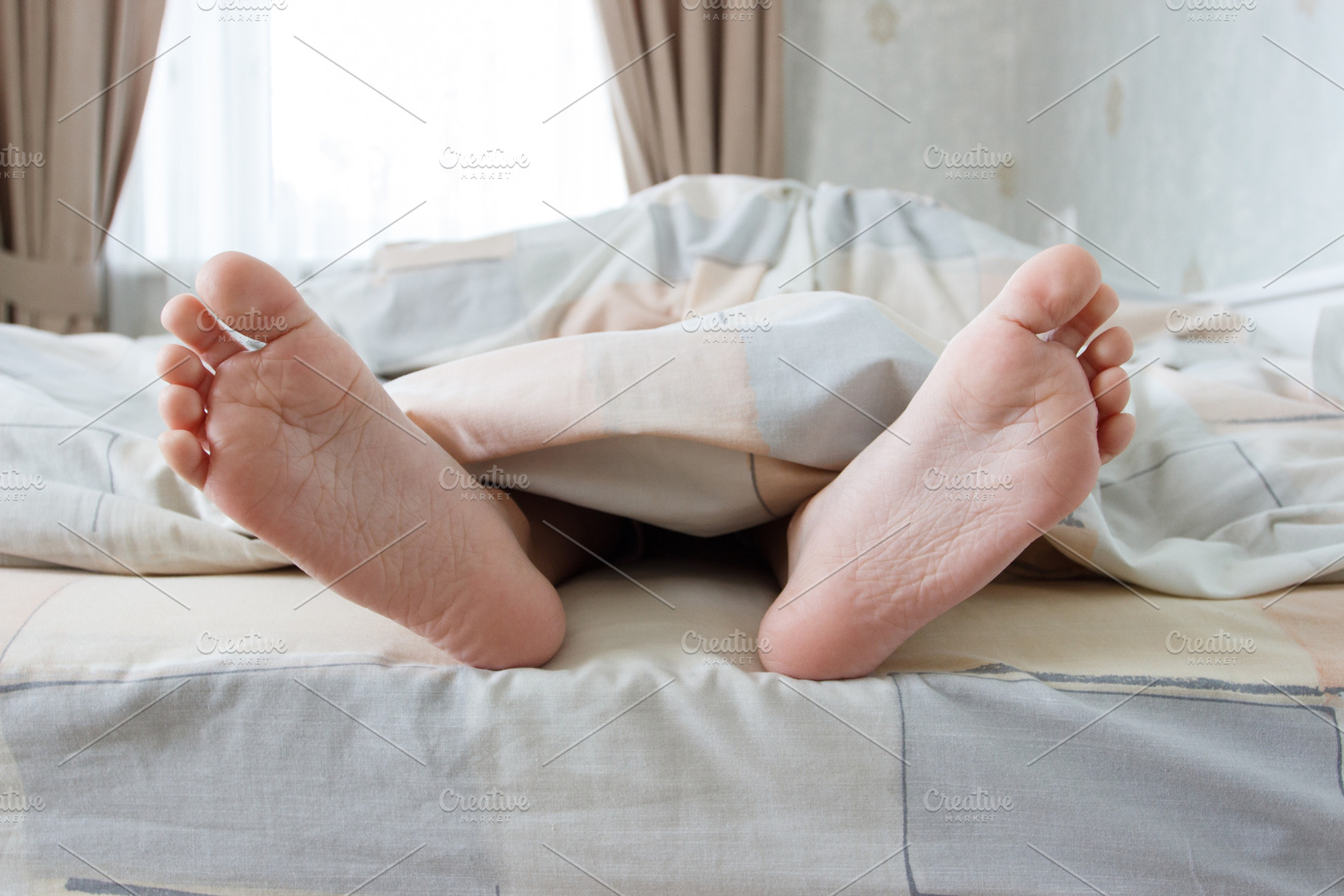 Feet under a blanket on the bed, a Person Photo by Lisssbetha