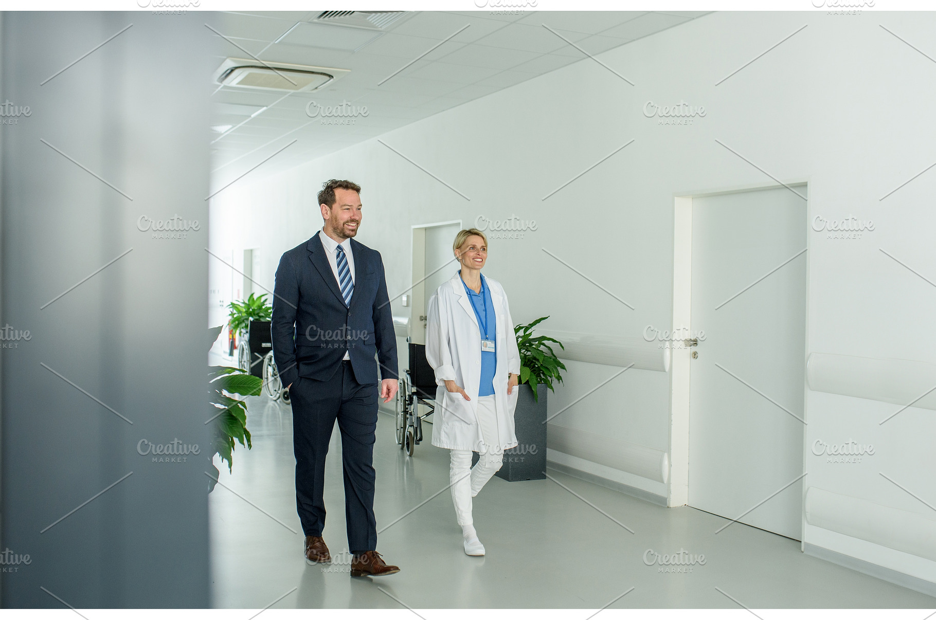Male hospital manager walking by, a Person Photo by HalfPoint