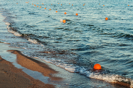 Sea with waves floats a lot of protective buoys, a Nature Photo by TanaCh
