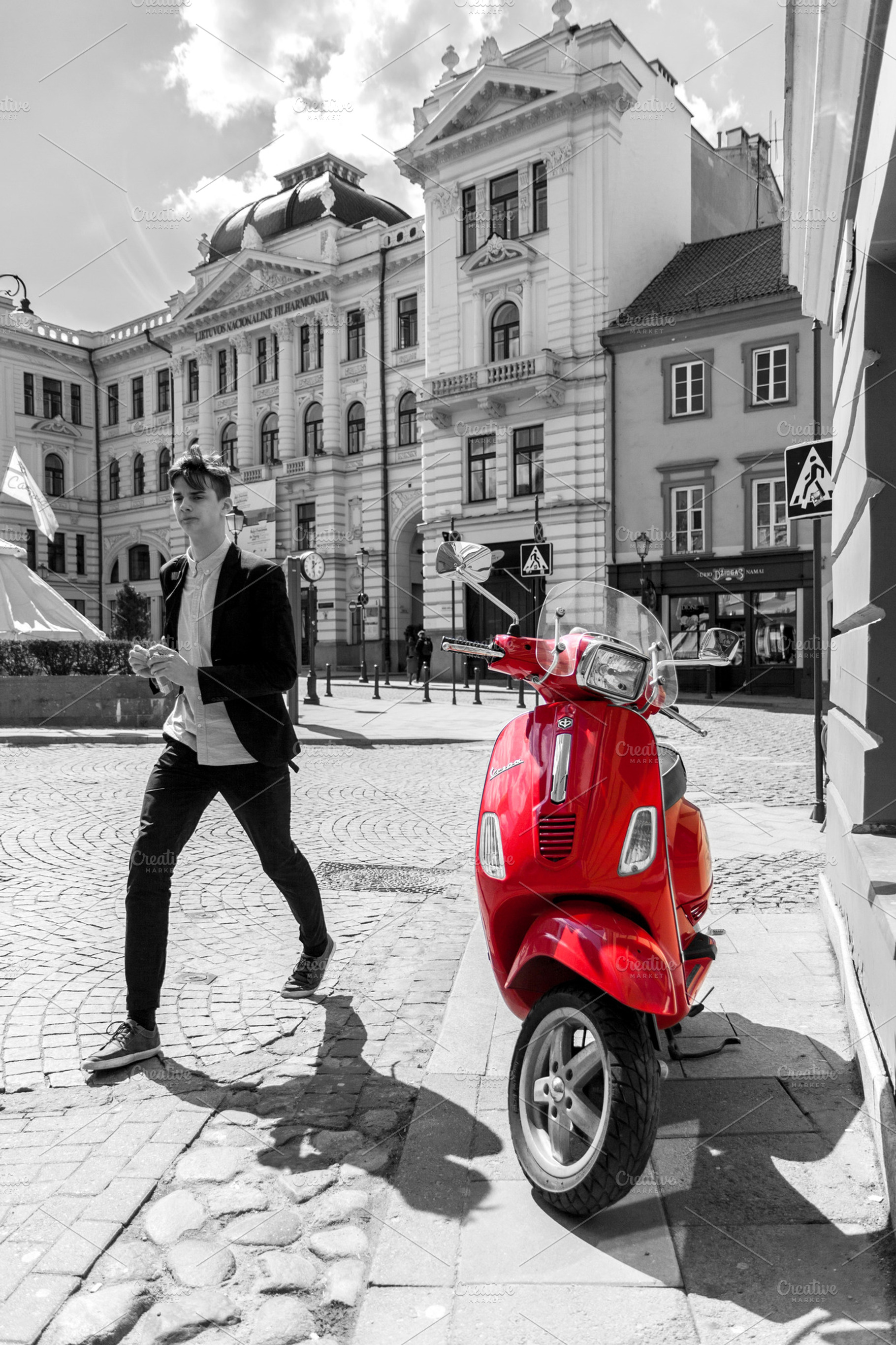 Red scooter on Vilnius street, a Transportation Photo by BOOCYS