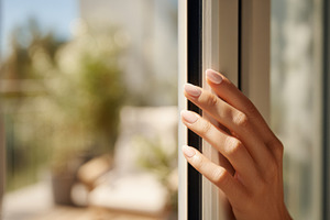 Hand reaching for the window