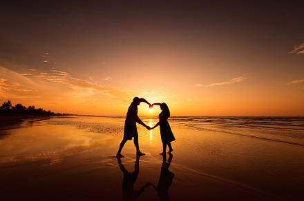 Silhouette of couple making heart