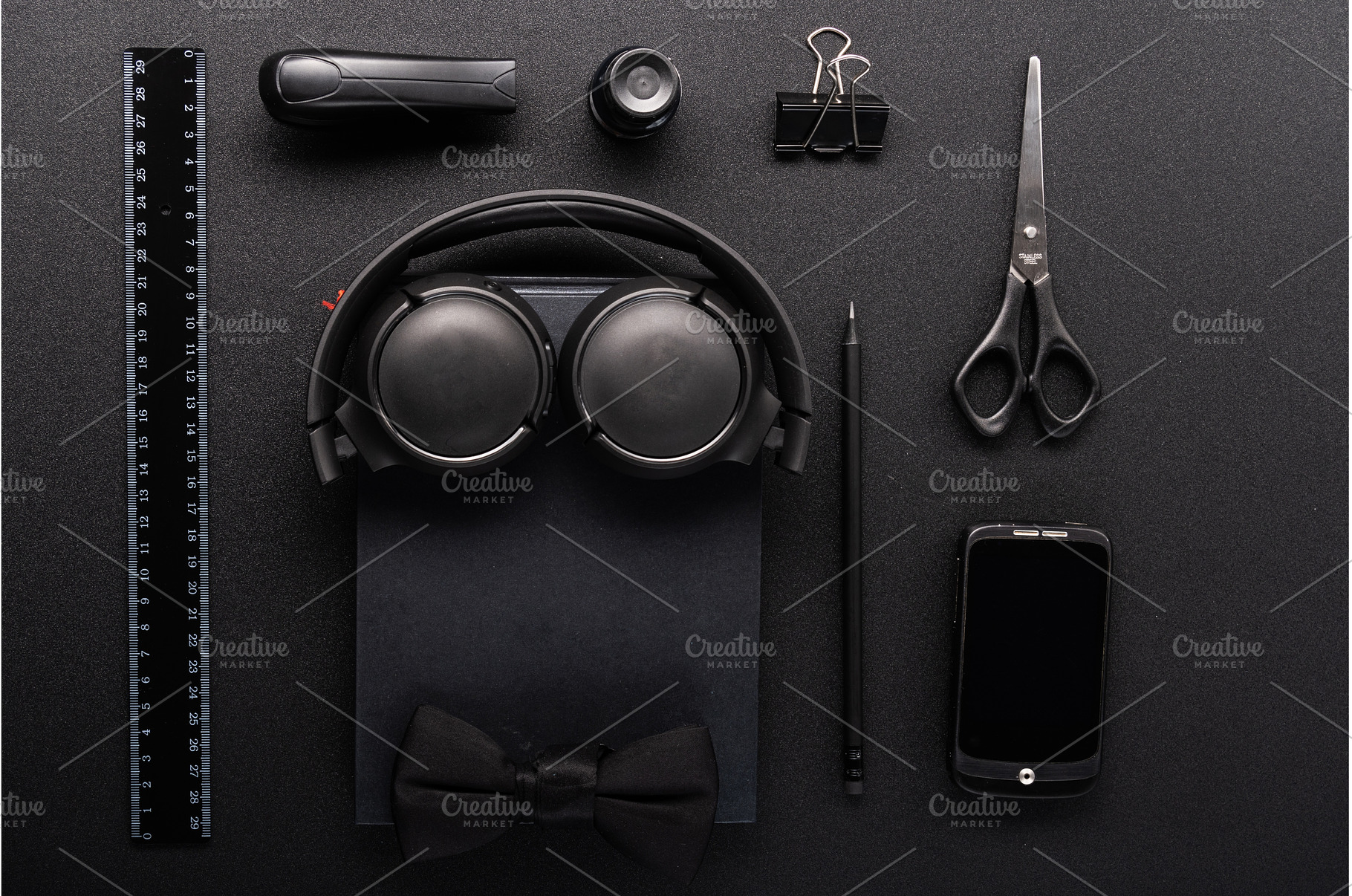 Flat lay of black stationery, a Background Photo by Stockphoto by vzwer
