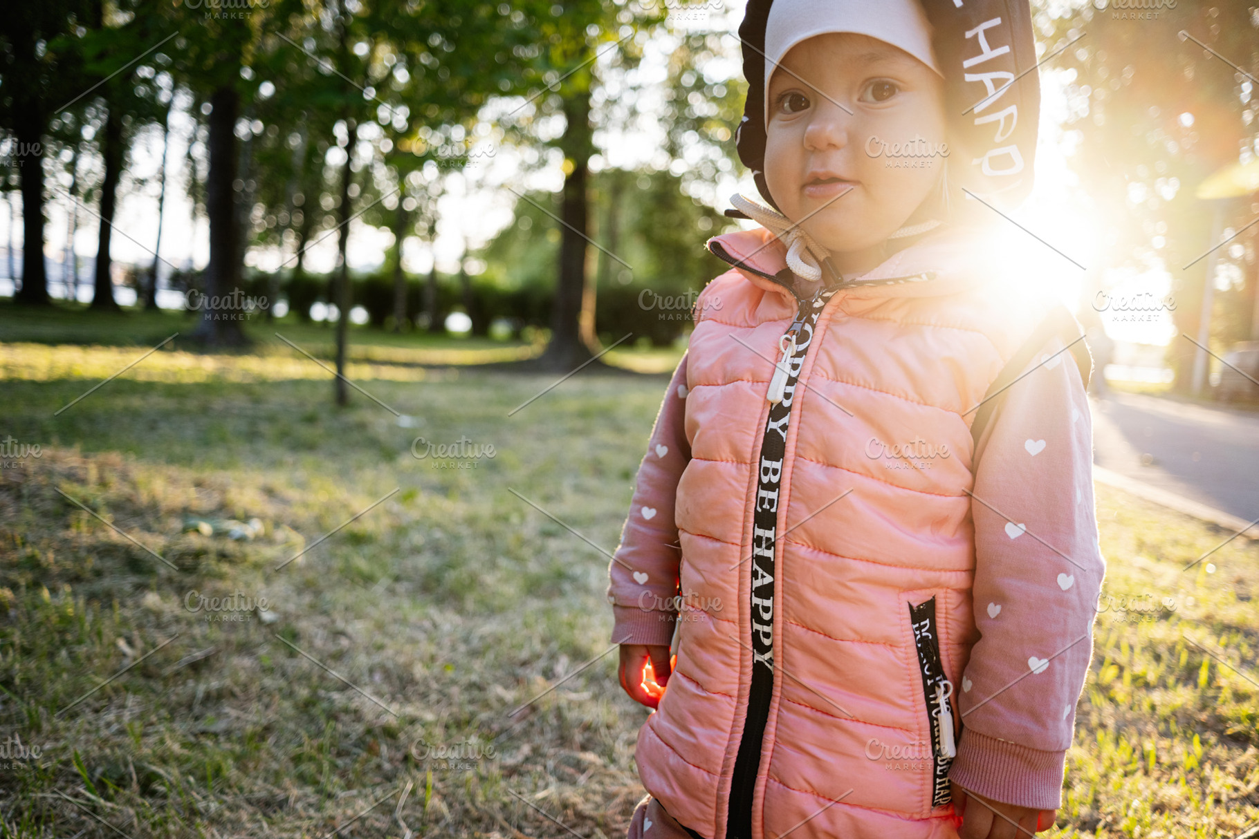 Young child in a park enjoying nature on a sunny day, a Photo by AS photostudio