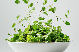 Fresh Green Salad Falling into Bowl, a Food & Drink Photo by Pixeness Studio