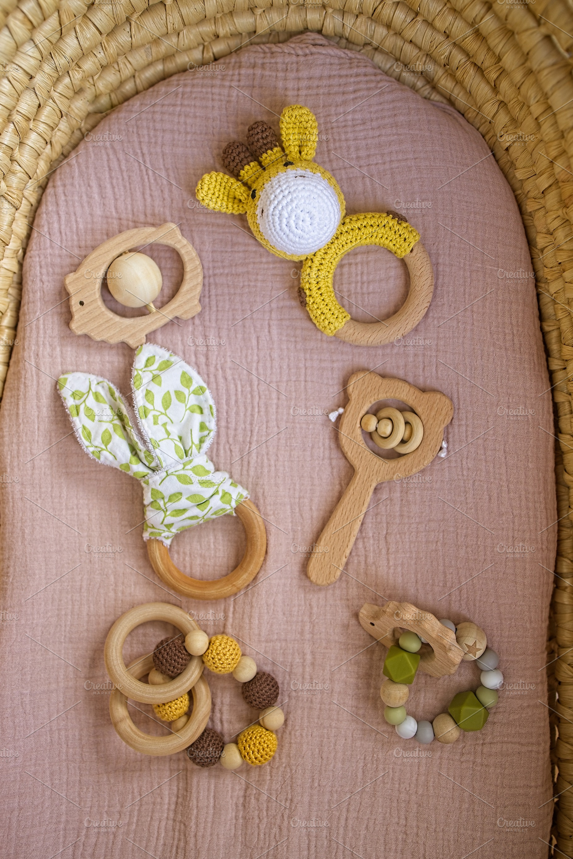in a basket natural wooden knitted toys for a newborn. View from above, a Beauty & Fashion Photo by TanaCh