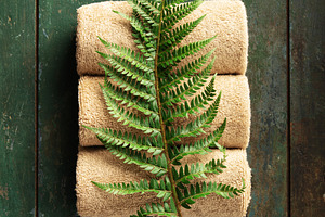 Natural Spa Towels with Green Fern Leaf on Rustic Wooden Backgro, a Beauty & Fashion Photo by Natalia Klenova's Shop