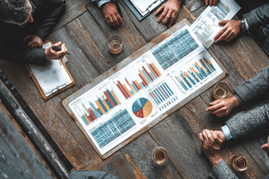 Business professionals discussing data visualizations and charts during a team, a Person Photo by AS photostudio
