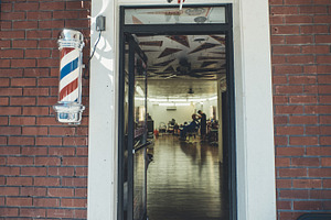 Guy Cutting Hair in a Barbershop
