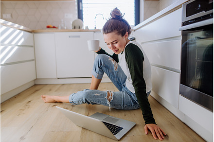 Young woman sitting with laptop and, a Person Photo by HalfPoint