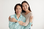 Joyful young Asian woman and her senior mother hugging and smiling at camera on, a Photo by Prostock-Studio (Thumbnail 1 of 3)