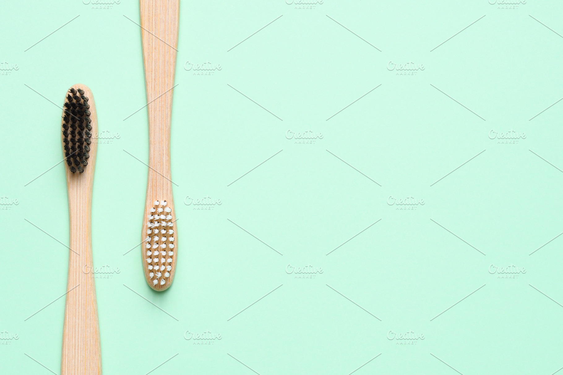 Bamboo toothbrushes on light green featuring toothbrushes, bamboo, and, a Health & Medical Photo by Anatoliy Sadovskiy