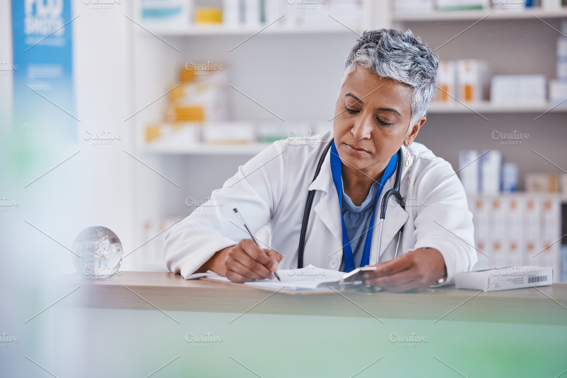 Woman, doctor and writing on clipboard at pharmacy for healthcare prescription, diagnosis or inventory at counter. Female medical professional taking notes on pharmaceutical products at the clinic, a Photo by Peopleimages.com