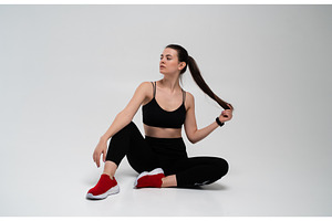 Fitness woman sitting on white, a Sports & Recreation Photo by volodymyrshtun13795