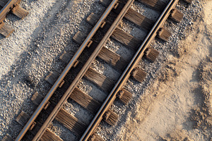 Rails line the ground in a construct, a Photo by Pavel_design