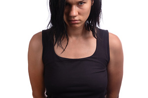 Young woman with black hair in a black tank top standing against, a Person Photo by Ales Munt
