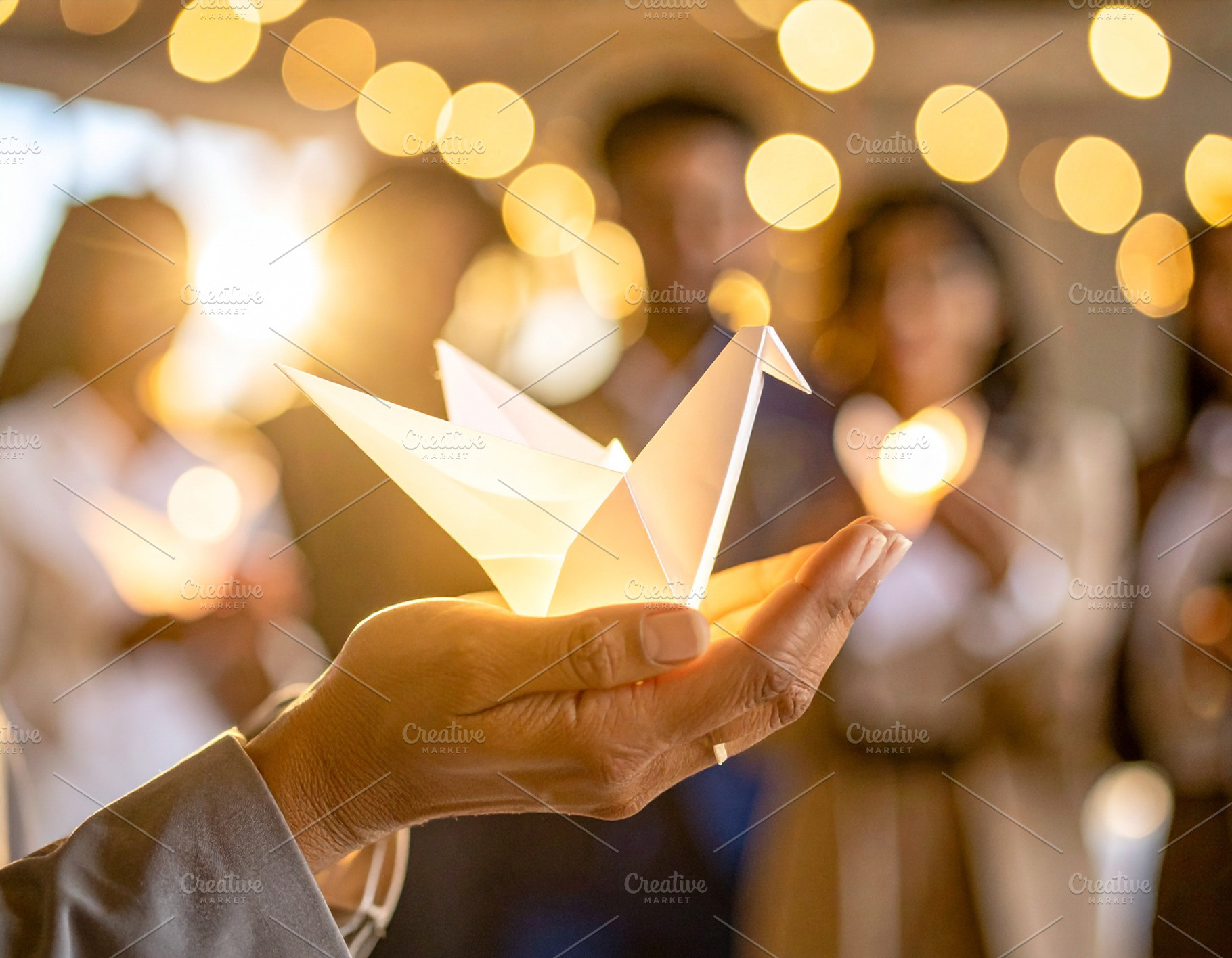 Business leader holding a glowing origami bird close to chest, a Technology Photo by DanFLCreativo