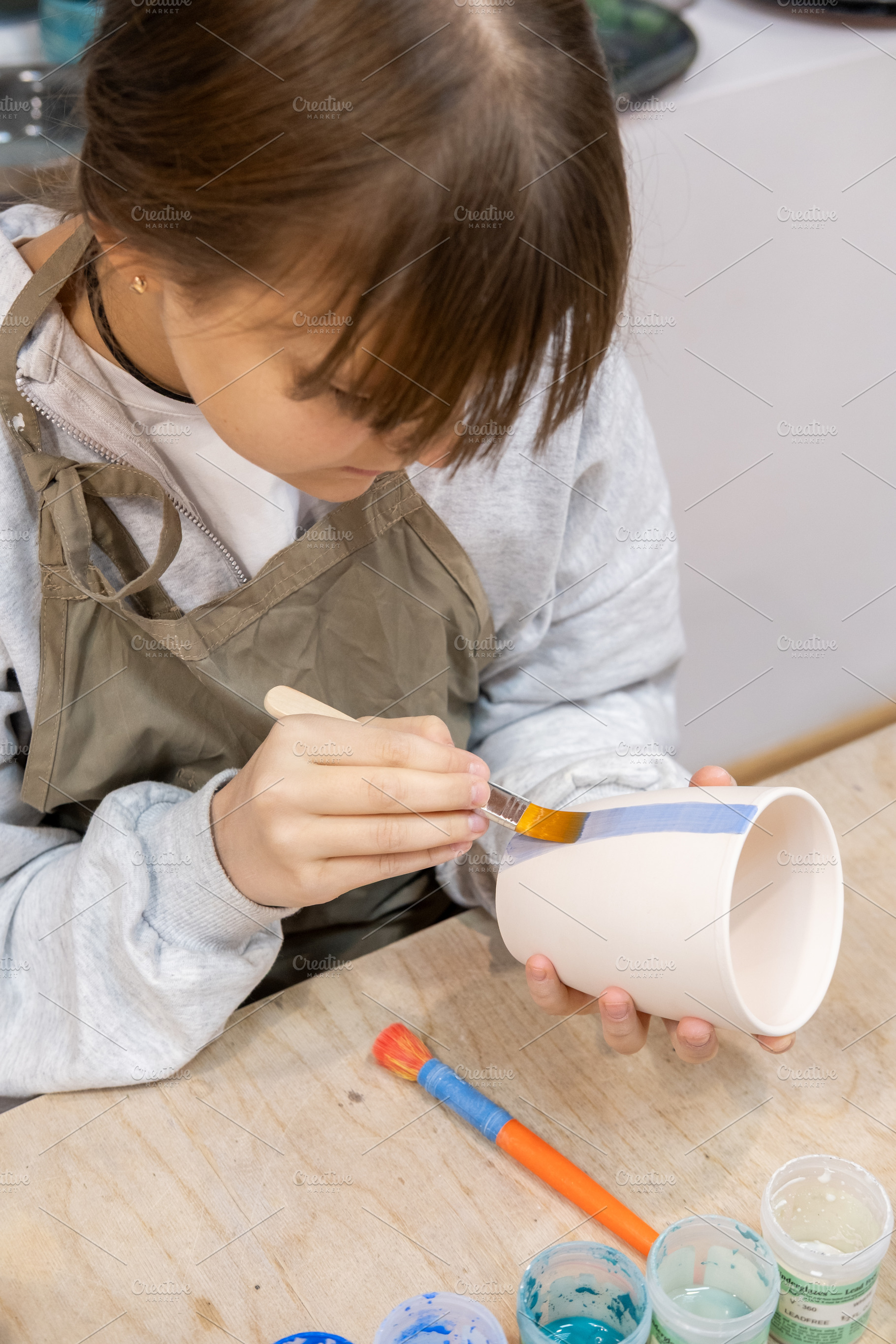 Coloring pottery handmade ceramic child painting, an Arts & Entertainment Photo by Photo Drive Studio