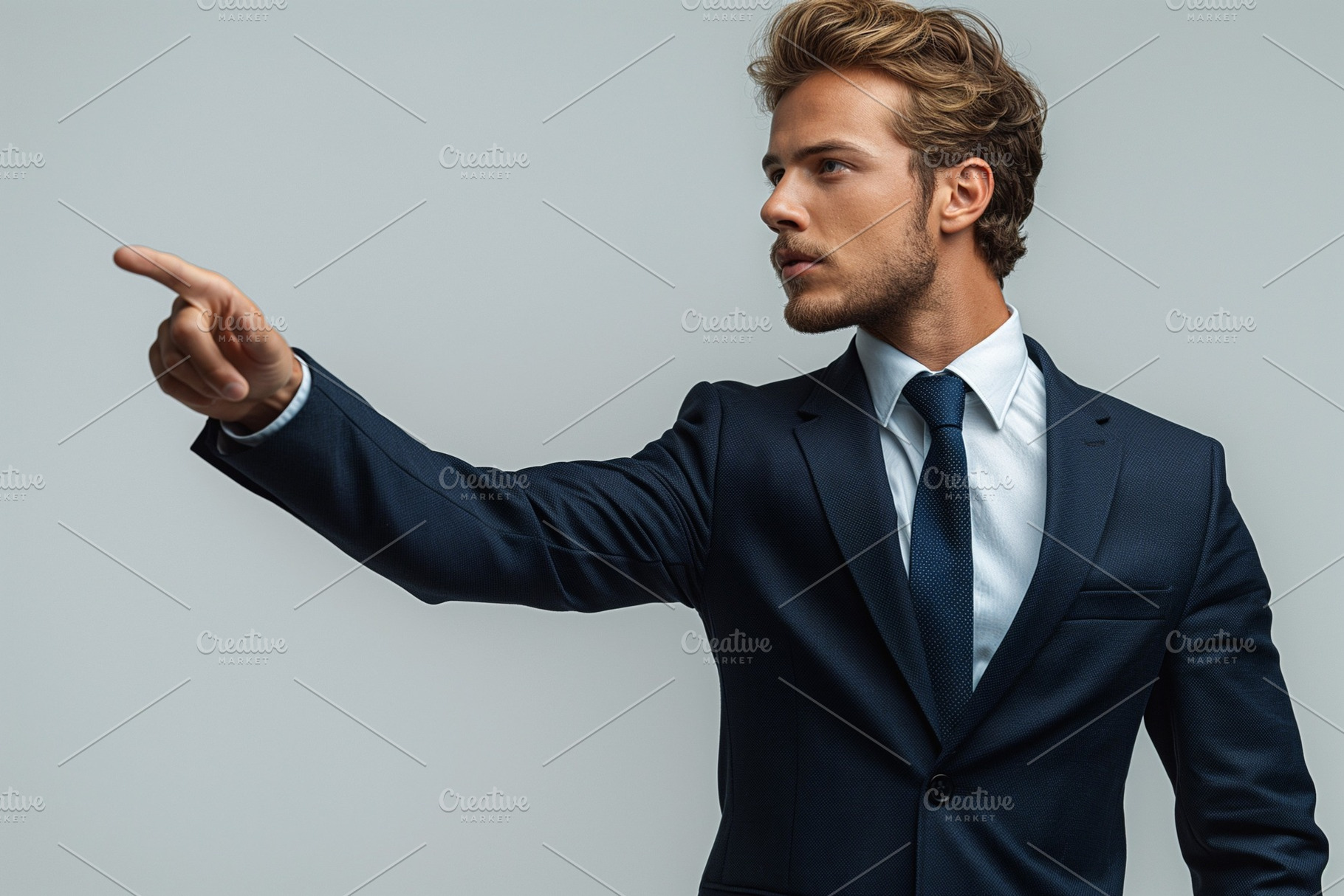 Confident young man in a suit pointing, exuding authority and determination., a Person Photo by ImageMir