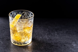 Rusty Nail Cocktail with Lemon Peel in Crystal Glass, a Food & Drink Photo by etorres69