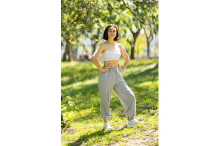 A woman is standing in a park
