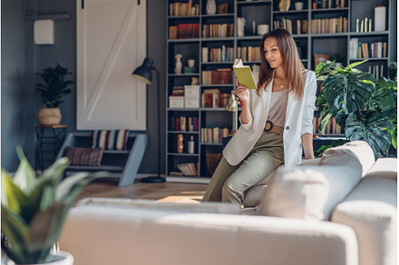 Woman sitting on couch and reading, a Person Photo by undrey