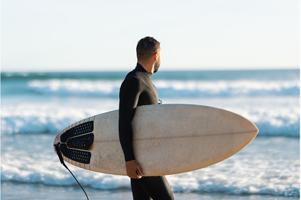 A man surfer in a wetsuit walking on, a Sports & Recreation Photo by Barcelona_dreams