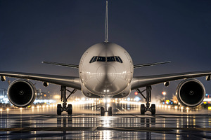 airliner on a wet runway at night, a Photo by rarrarorro