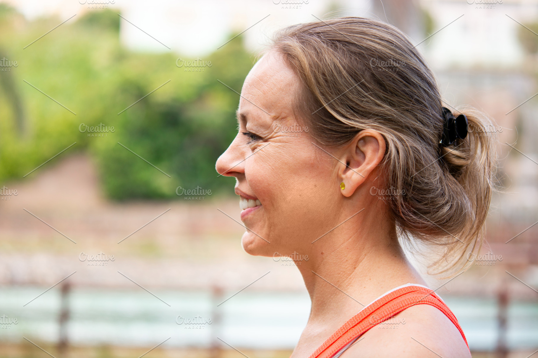 Side profile portrait of smiling mature woman during outdoor workout, a Person Photo by etorres69