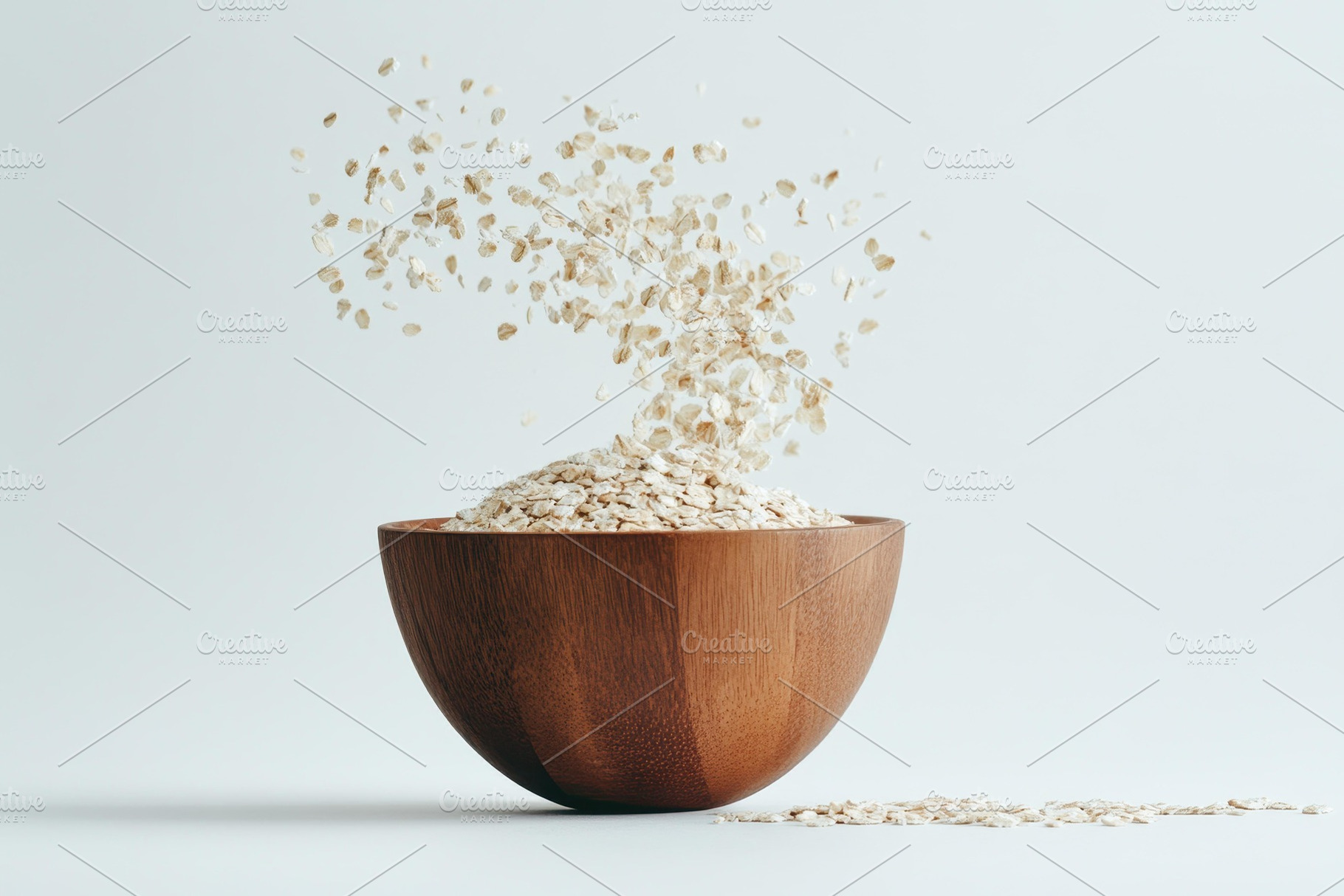 Oats flying from a wooden bowl on a, a Photo by Tanuart