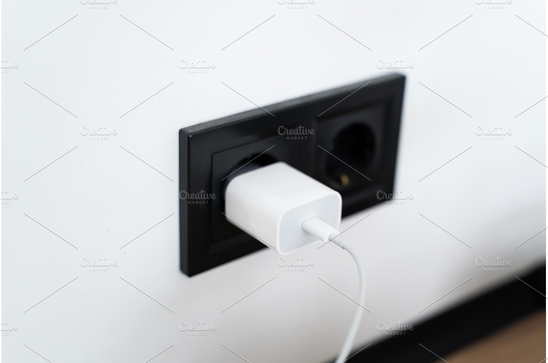 White USB charger plugged into black, a Technology Photo by volodymyrshtun13795