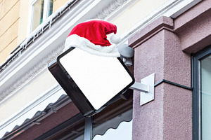 Company signage with Santa hat, a Business Photo by BOOCYS