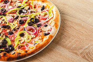 Pizza close up on a wooden table featuring dough, eat, and fast food