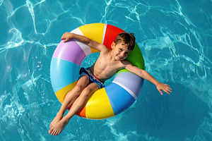 Child floating on colorful pool ring, a Sports & Recreation Photo by Davizro's Market