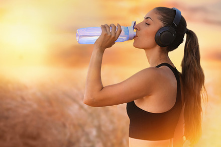 Sportswoman drinking water at sunset, a Person Photo by Perpis