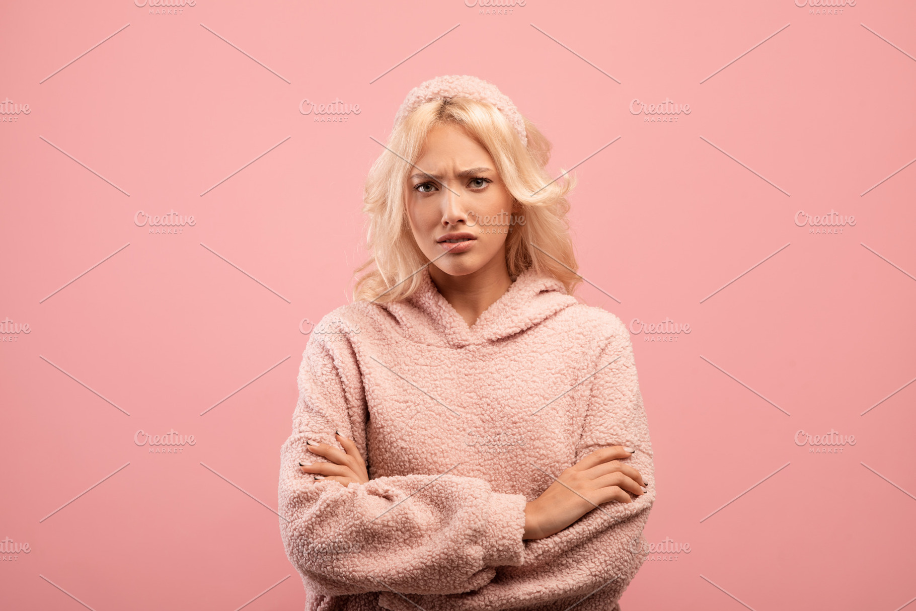 Offended lady standing with folded arms and looking at camera, grumpy woman fee, a Photo by Prostock-Studio