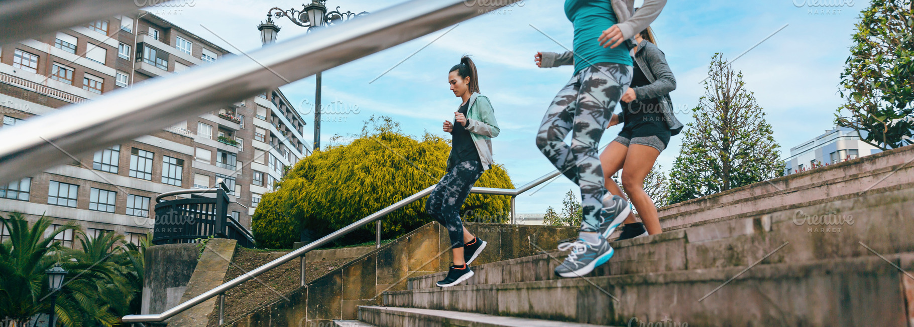 Young women friends training running down stairs in town, a Sports & Recreation Photo by davidpereiras