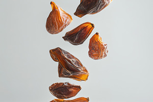 Delicious dried dates isolated on tr, a Food & Drink Photo by Pixeness Studio