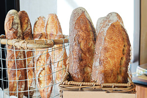 Freshly baked French bread showing texture and golden crust, a Photo by salmon.black