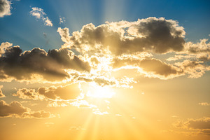 Sunset sky with clouds and sun