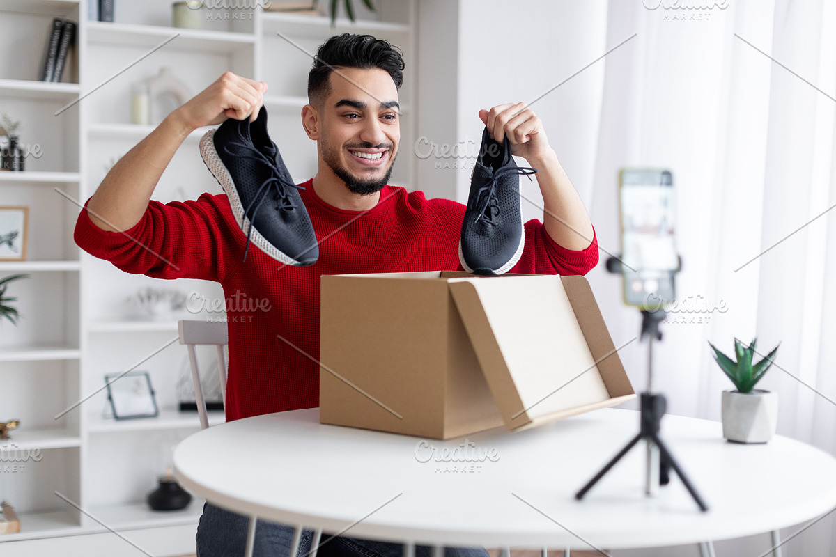 Unboxing Video. Arab Male Blogger Recording Content For His Blog At Home, a Photo by Prostock-Studio (Photo 1 of 2)