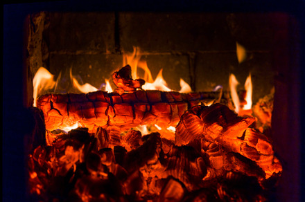 Fire containing fireplace, fire, and coals