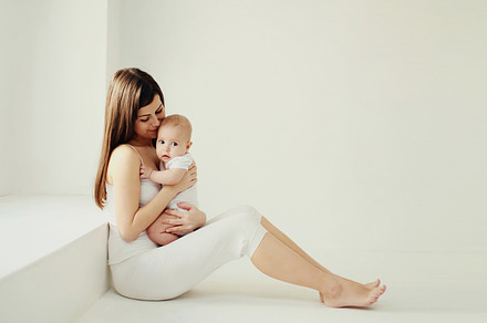 Happy young mother holding cute baby, a Person Photo by Rohappy