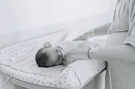 The hands of a mother changing her newborn in the hospital, a Person Photo by rubenchase
