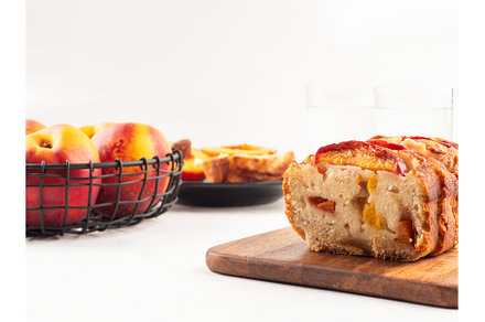 Peach cake loaf on wooden cutting