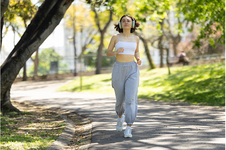A woman is running in a park with