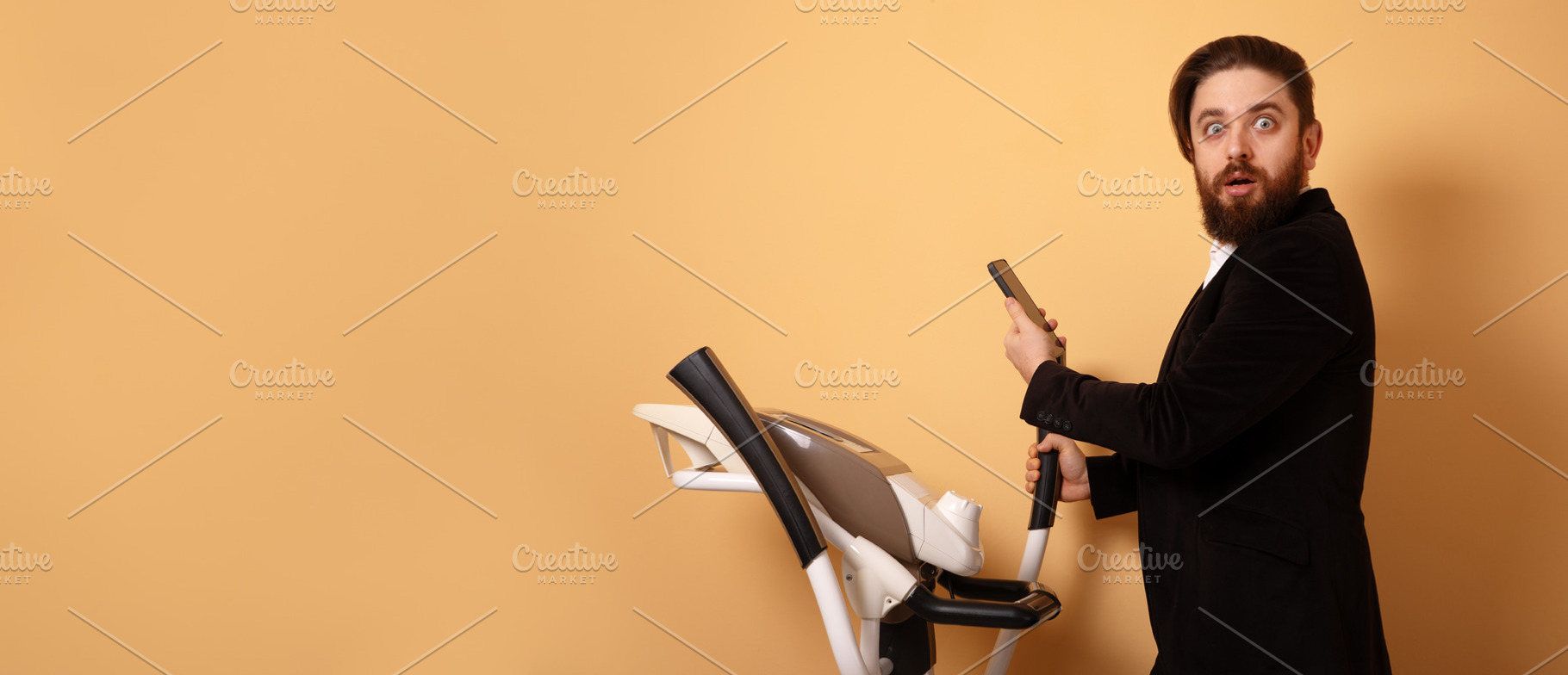 Bearded man in suit holding phone, shocked expression, standing, a Person Photo by Ales Munt