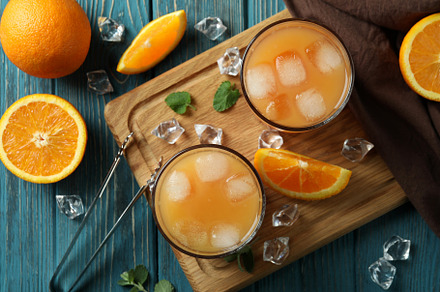 Tequila Sunrise cocktails and ingredients on wooden table, a Food & Drink Photo by AtlasStudio PRO