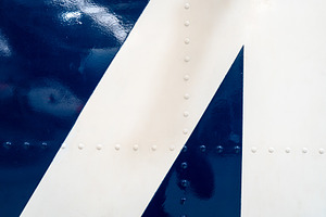 Close-up of riveted blue and white aircraft fuselage with glossy, a Background Photo by GoodGoods