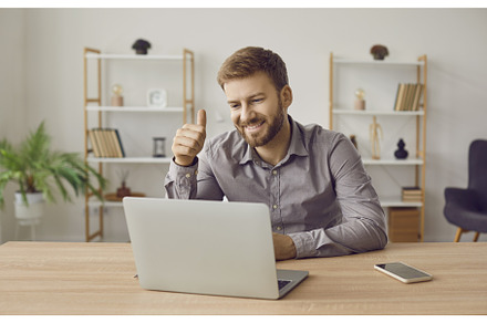 Happy business man using laptop, a Technology Photo by StudioRomantic